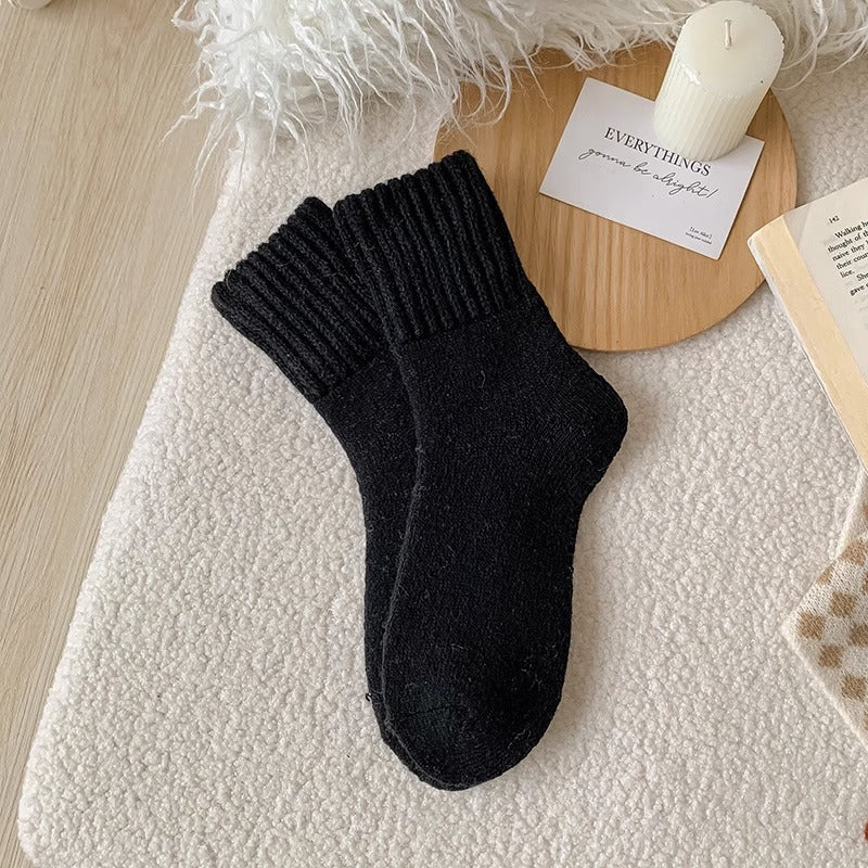 A pair of Black Hushwoven socks with a fold-over ribbed cuff
