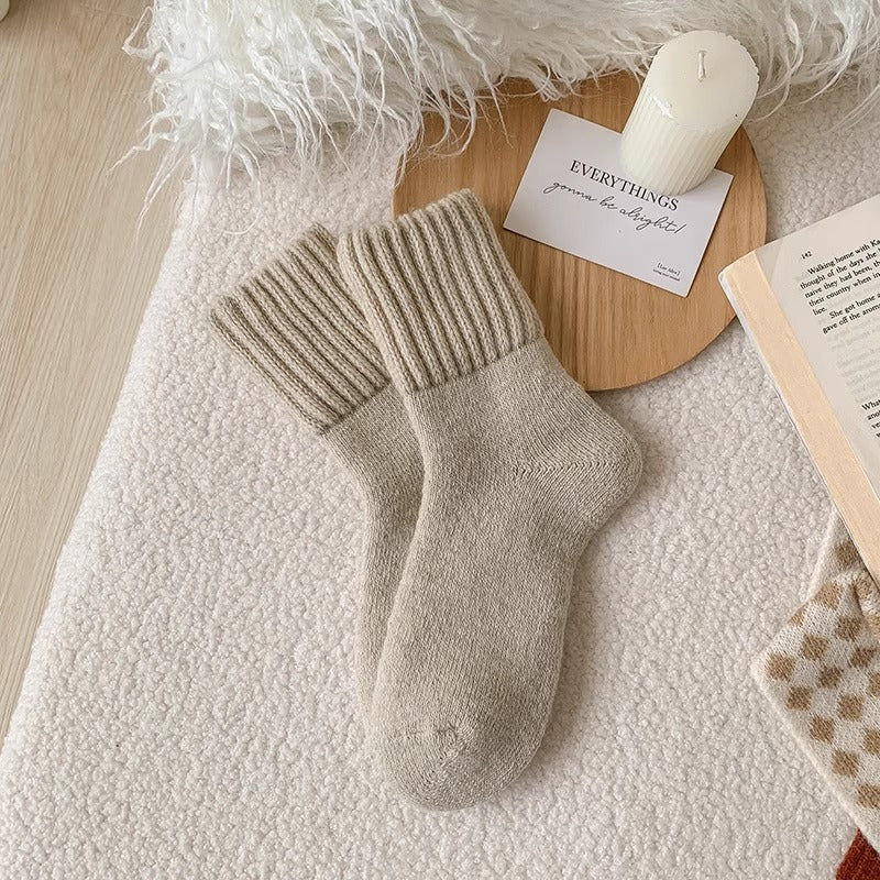 A pair of Cream Hushwoven socks with a fold-over ribbed cuff