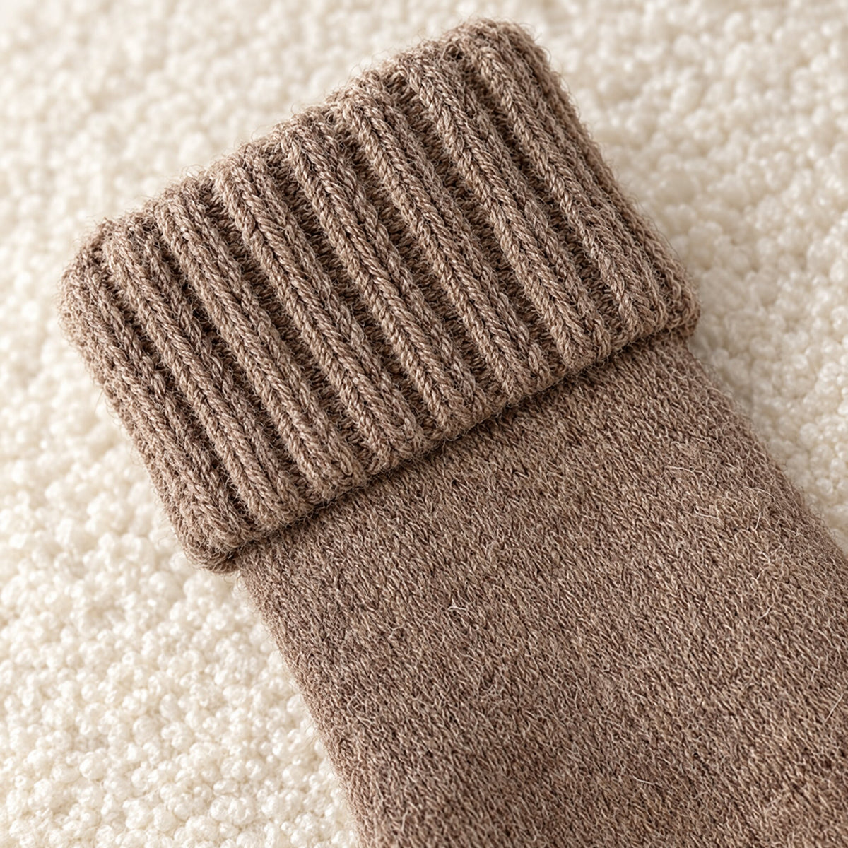 Close-up of the ribbed fold-over cuff on a taupe sock